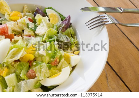 Fresh Mixed salad with eggs, tomatoes, iceberg and roman salad, bell pepper and croutons