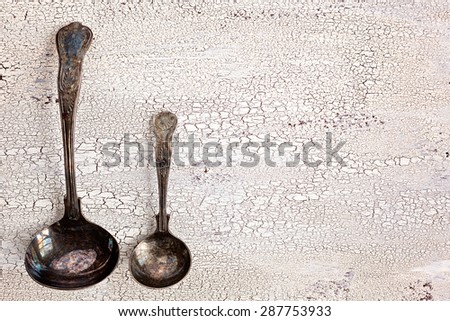 Old cutlery cracked white wooden background