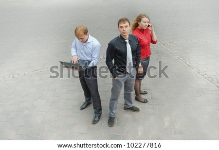 Image of a business team using communication and standing on the street. They have many ideas.