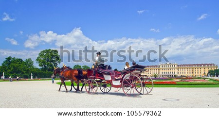 Image coach with tourists in the background of an ancient castle in Vienna, Austria.