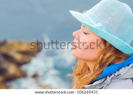Portrait of a girlÃ¢Â?Â?s face, resisting strong winds at the edge of the world - Finister in France.