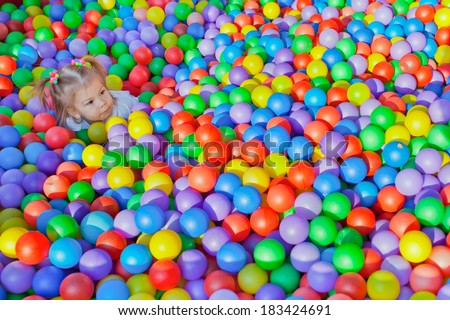little children on the background of many small balls