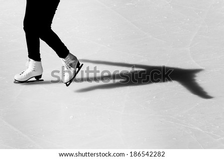 Image of people who are ice skating in the ice rink at the Medeo