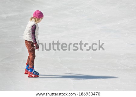 Image of young girl who are ice skating at the ice rink outdoors at Medeo
