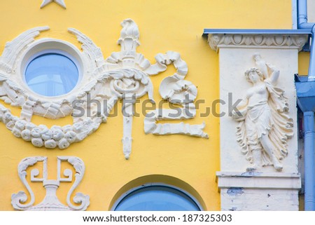 old yellow building with architectural molded figures in Kiev, Ukraine