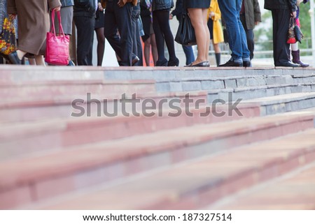 Crowd of people walking on stairs on a city street