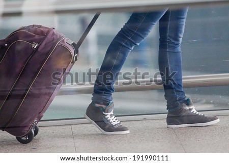 Woman carries your luggage at the airport terminal of Hong Kong