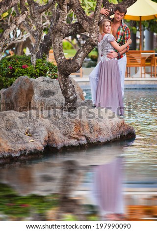 couple in love near the hotel resort with reflection