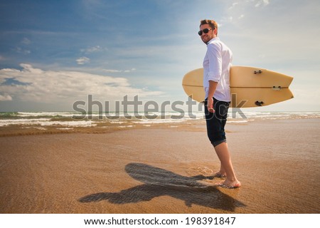 office worker enjoying their recreational activities near the sea with surfboard