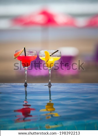 Orange and watermelon cocktail with cocktail straw on bright background