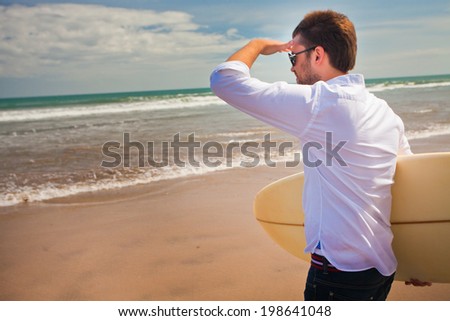 office worker enjoying their recreational activities near the sea with surfboard