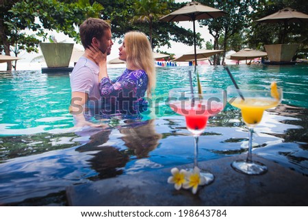 first date lovers at water in pool, near hotel
