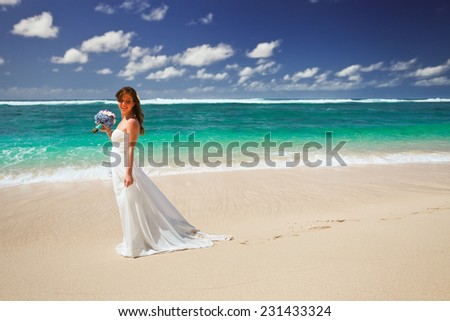 Bride with wedding bouquet on the beach, Bali