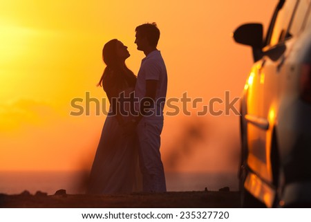 Sunset background of silhouette couple, they travel by car