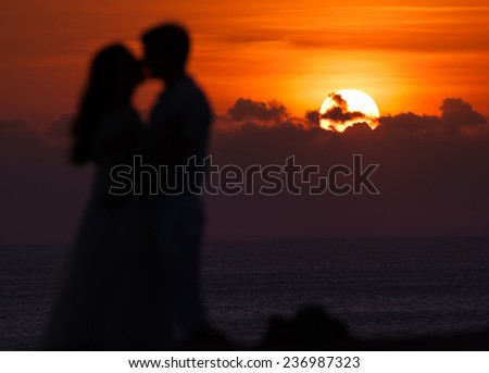 First date of a couple at background silhouette, focus on the sun