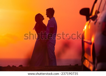 Sunset background of silhouette couple, they travel by car
