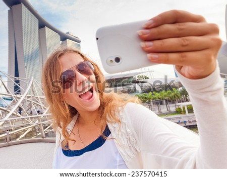 Young woman taking pictures of her self, selfie to instagram