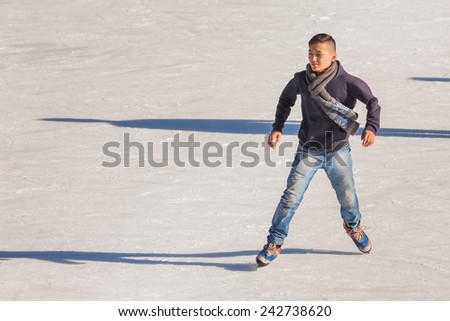 Image of young man who are ice skating at the ice rink outdoors at Medeo