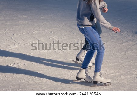 Image of young girl who are ice skating at the ice rink outdoors at Medeo