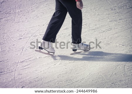 Image of adult who are ice skating at the ice rink outdoors at Medeo