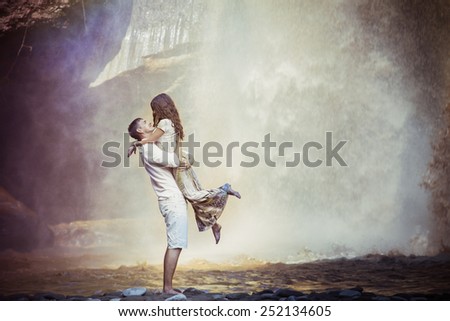 retro revival photo of couple travels to balinese waterfall