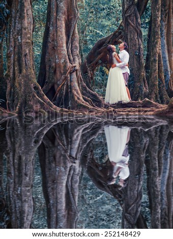 unusual wedding couple in mysterious fairy forest