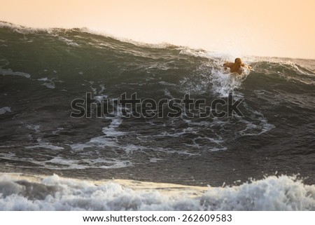 Surfer on big Ocean Wave in Bali, Indonesia