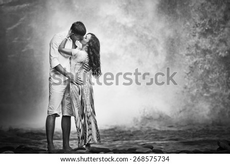 retro revival photo of couple travels to balinese waterfall, black and white