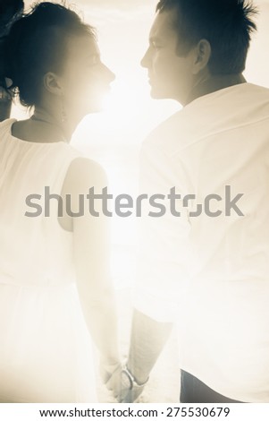 background of young happy couple dressed in white with sun light, abstract image for any romantic idea and copy space