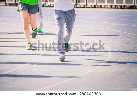 background of marathon, blurred motion a crowd of people jogging outdoor by road with copy space for text