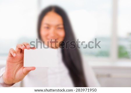 Happy and successful asian businesswoman gives you a business card or visiting card with a white background on a blank for copy space and any contacts or phone number