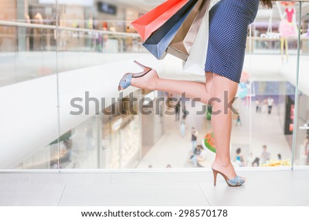 Closeup fashion woman\'s legs runs or rush for shopping discounts and sales at the big mall centre. Concept of shopping or shopaholic, sale and discounts at boutique