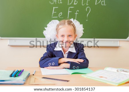 Desktop background of student sitting at a desk, thinking about her spend summer and ready to writing it to notebook. On table there is a copybook, a ruler, and copy space for text