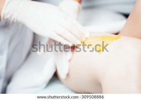 Sugaring epilation skin care with liquid sugar at legs. You can see her smooth and hair free armpits after hair removal.
