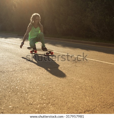 teenager riding skateboard longboard by road outdoor at mountain