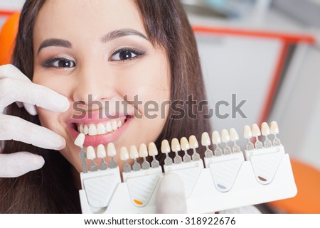 Beautiful asian woman smile with healthy teeth whitening. Dental care concept. Set of implants with various shades of tone