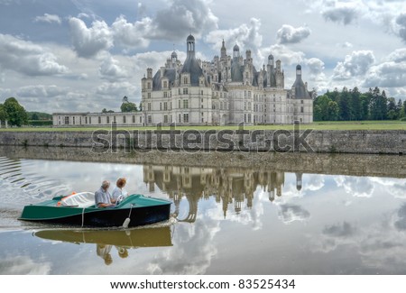 Old couple grandmother and grandfather travel together by boat in Loire, France. Castle Chambord, Leonardo da Vinci. They are together a many long years.