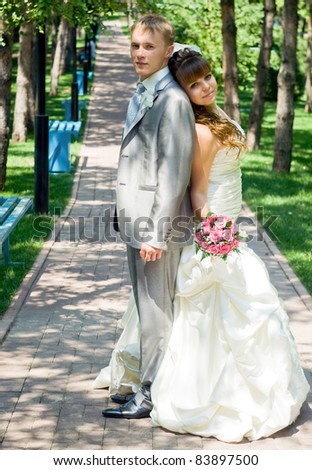 Portrait of beautiful happy couple, Just Married with Bouquet of Flower