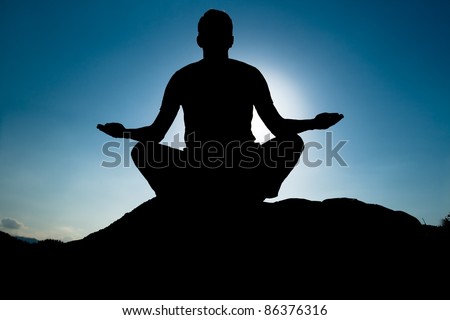 Silhouette of Yoga at summit. Young adult at the top of summit with aerial view of the blue sky