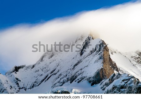 Summit of jungfrau - top of Europe in Grindelwald ski area. Switzerland. There are a blue sky and clouds