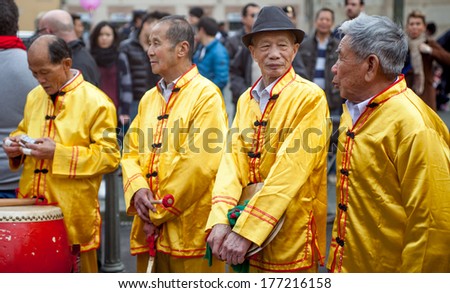 PRATO, ITALY - FEBRUARY 16: Four old men relax at the end of the parade parade during the traditional Chinese New Year celebration, on February 16, 2014 in Prato (Italy)