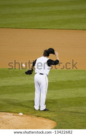 pitcher catching a baseball
