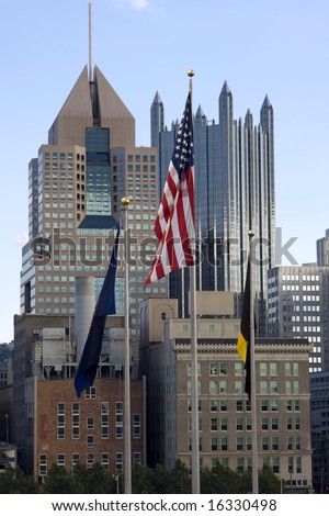 American flag waving in front of downtown Pittsburgh city