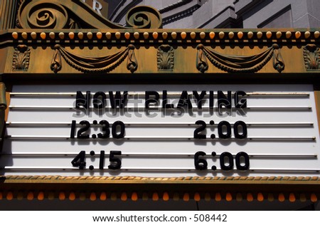 A theater marquee with show times.