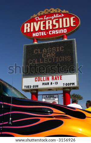 At Don Laughlin\'s Riverside Hotel and Casino in Laughlin, Nevada, is a marquee advertising a classic car collection museum there. In the foreground is a PT Cruiser.
