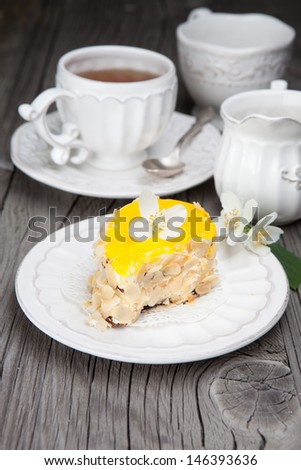 Dessert - tasty sweet cake on a plate with flowers on a dark wooden background