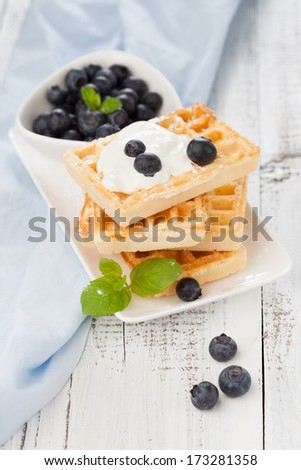 Delicious Belgian waffle with fresh berries and cream for breakfast