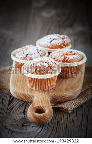 Homemade sweet muffins on dark wooden background, selective focus
