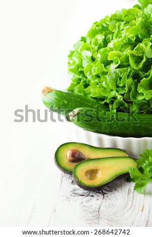 Fresh green vegetables on white wooden background, selective focus