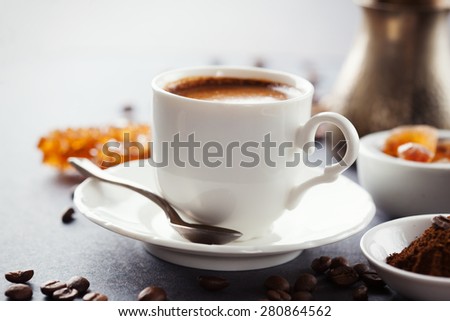 Crispy fresh croissants and cup of coffee on a black background, morning breakfast, selective focus